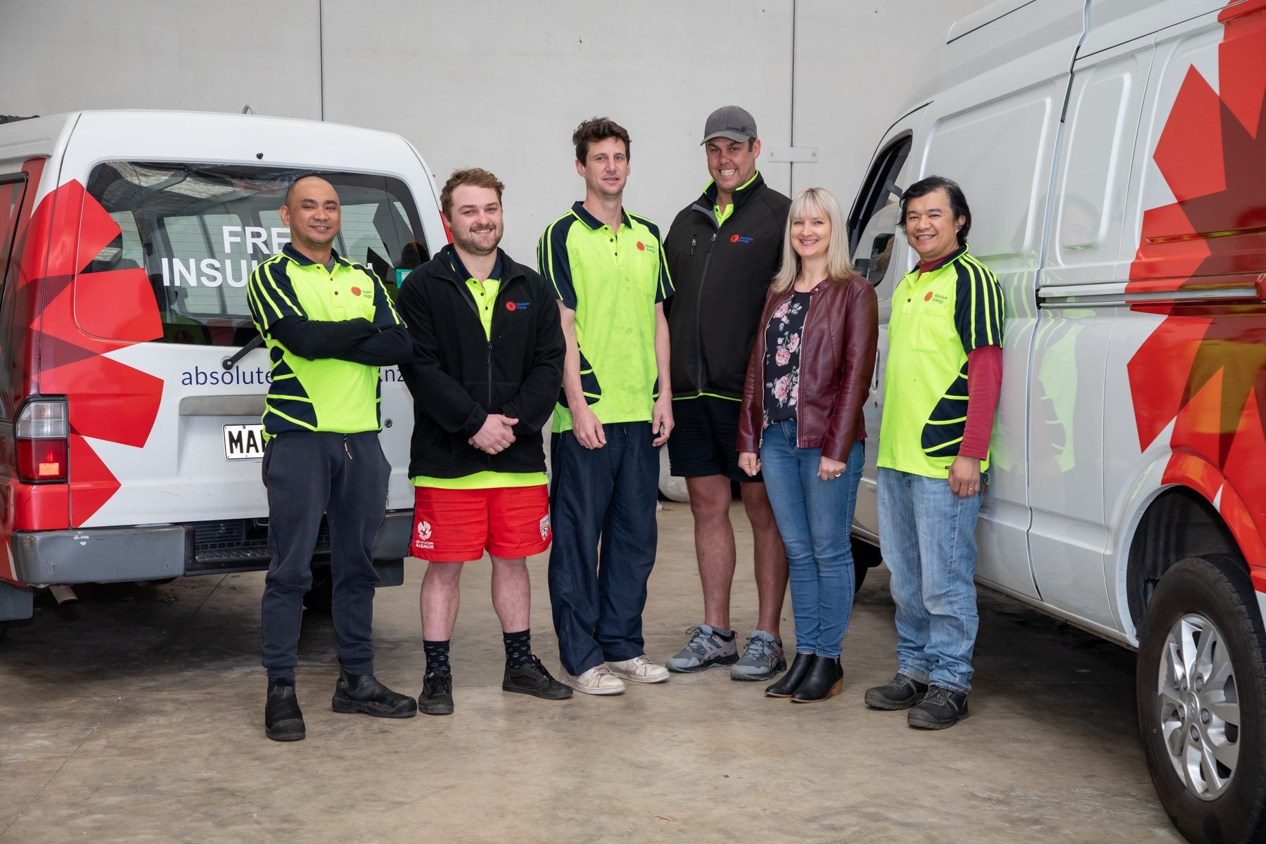 The Dunedin team in front of the branded vans
