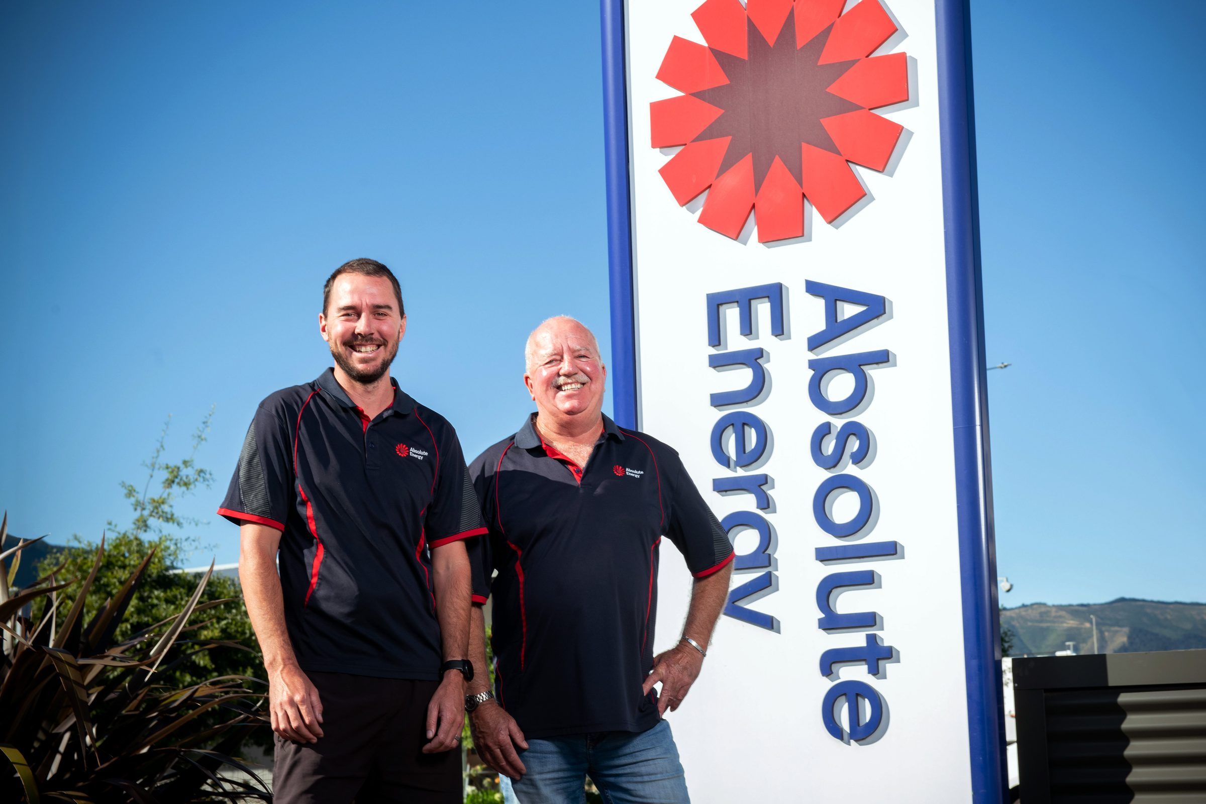 Troy and Paul Brockie stand beside the new Absolute Energy sign