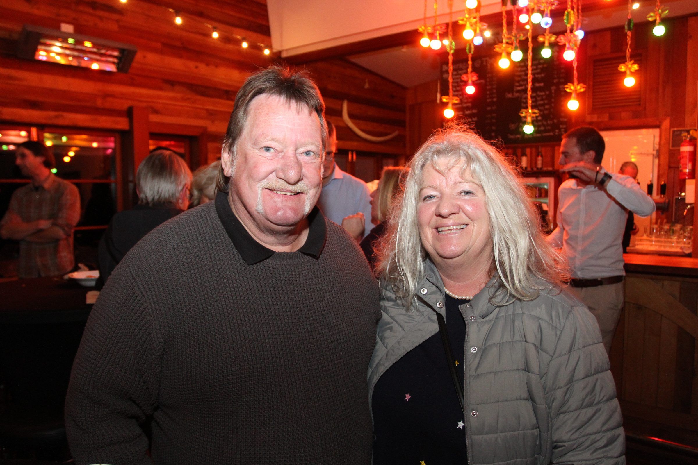 Two guests smiling at the 20-year celebration