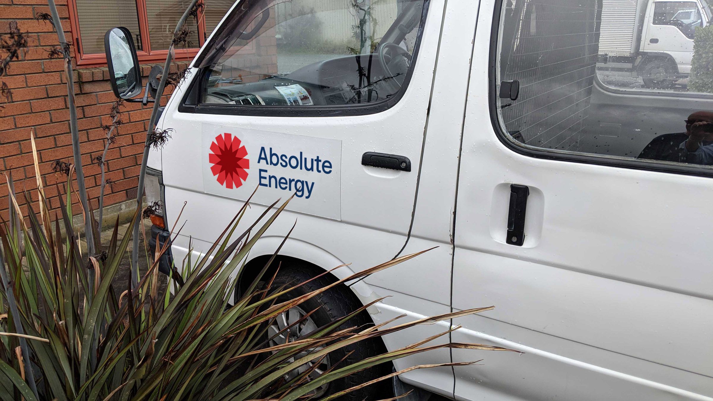 The Absolute Energy logo on the side of a van