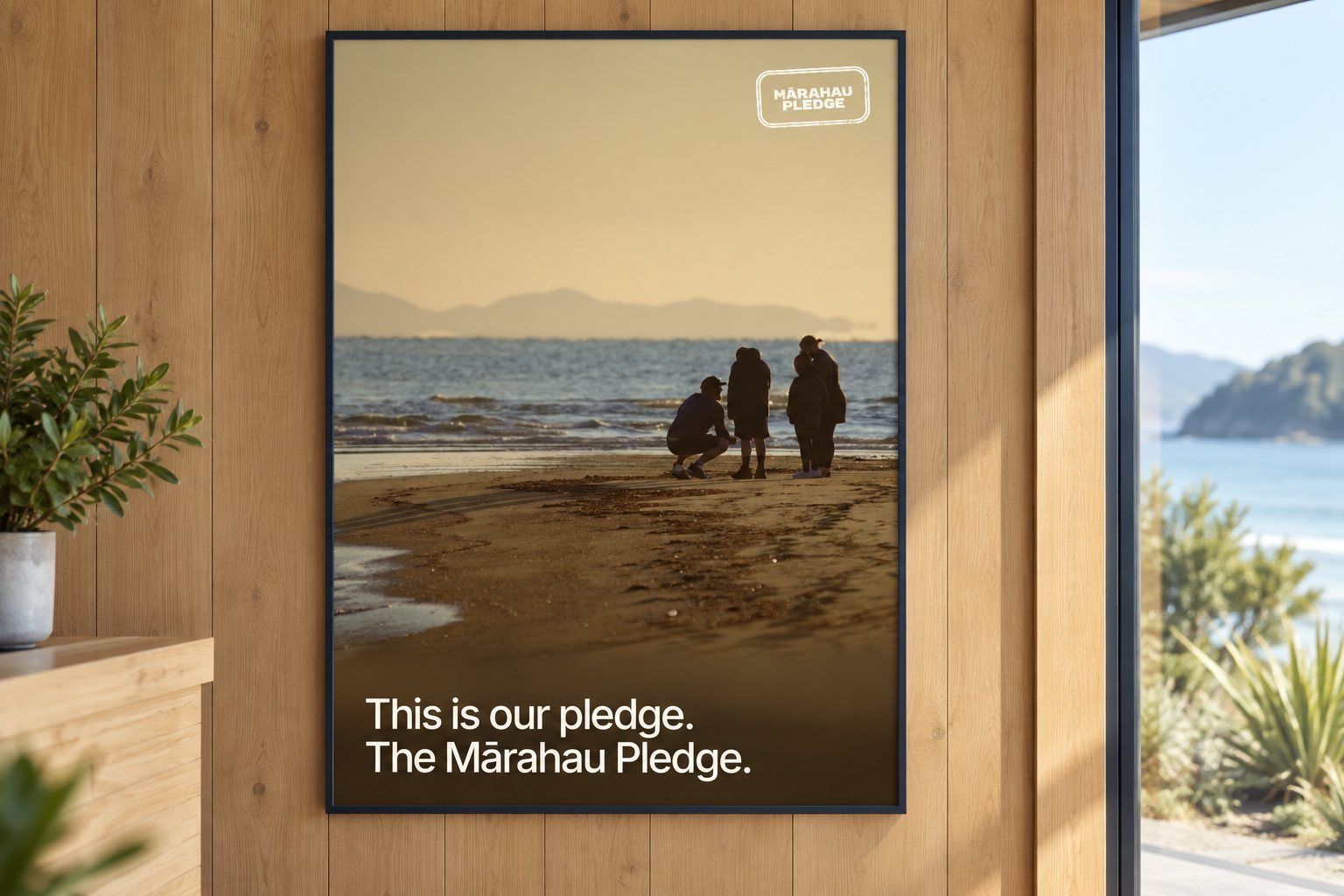 The Mārahau Pledge poster framed on a timber wall beside a window