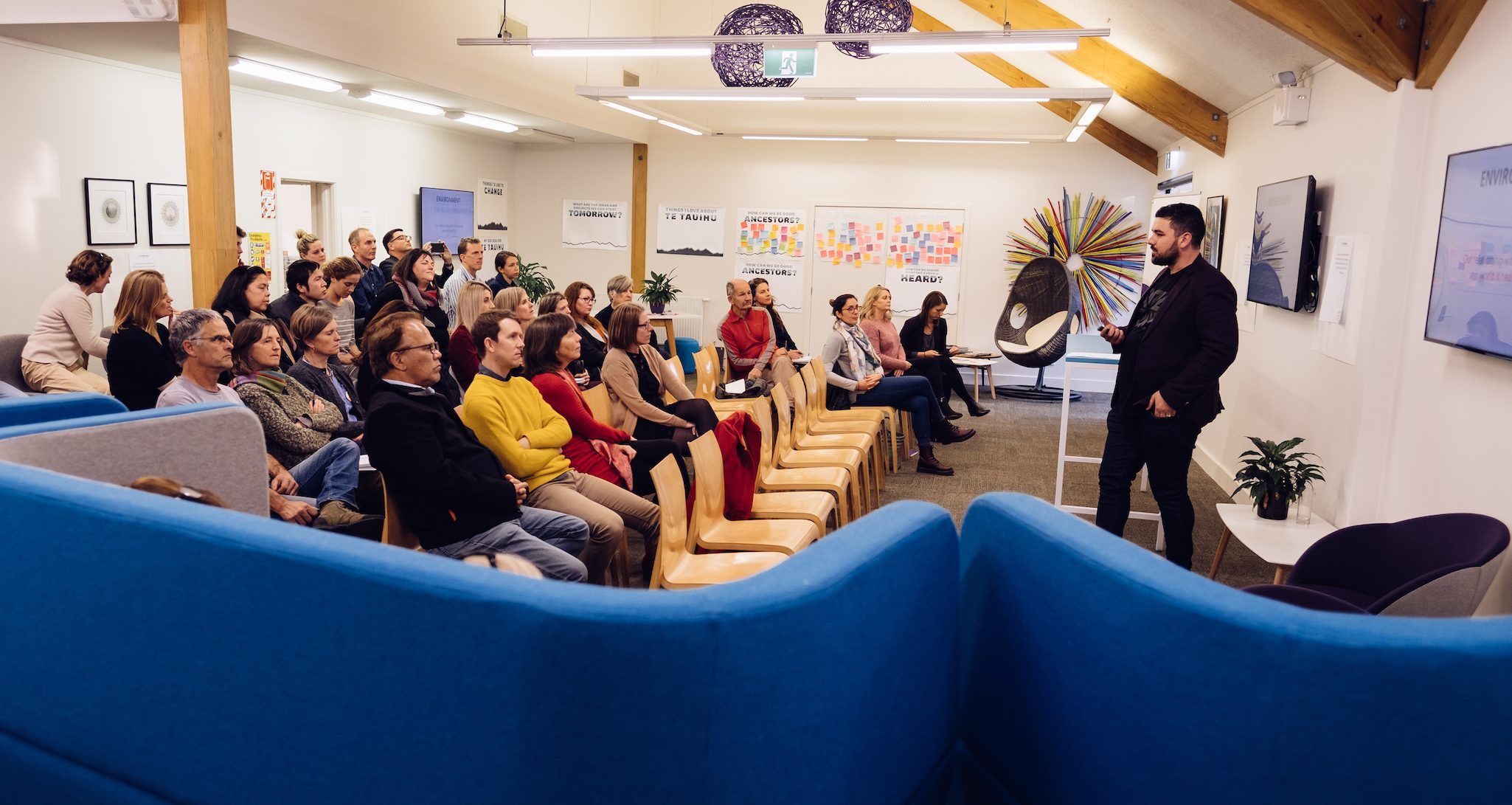Johny O’Donnell speaks to a community hui seated around the room