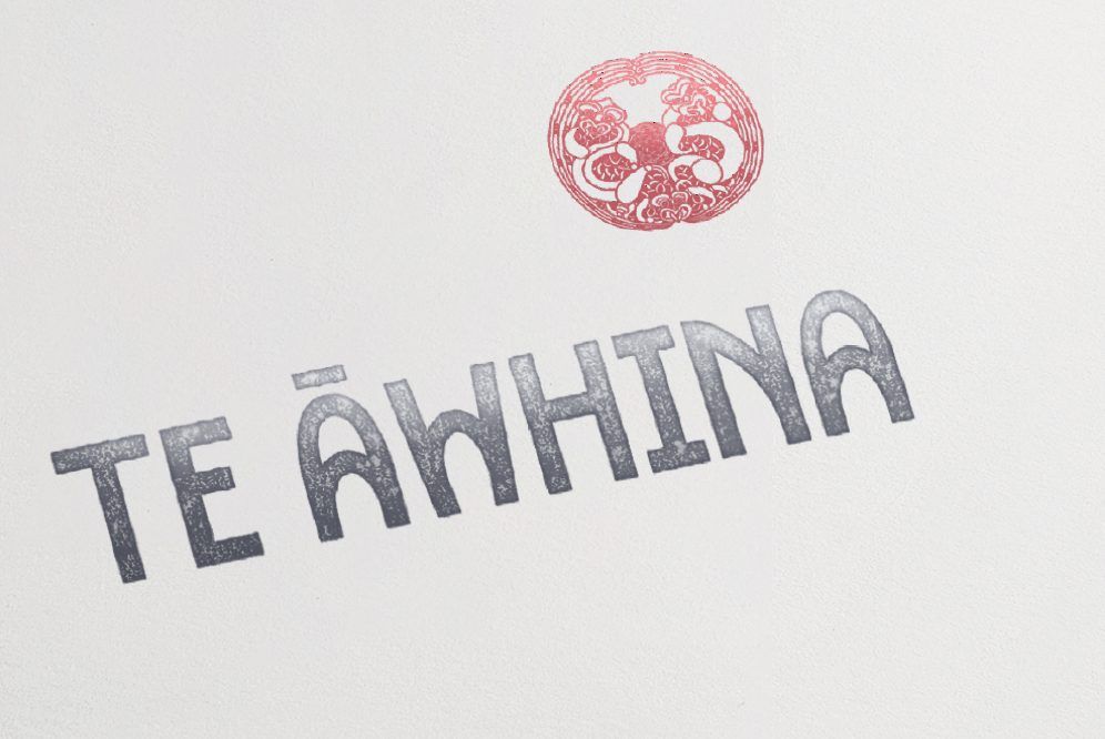 The Te Āwhina wordmark and carved emblem printed on paper