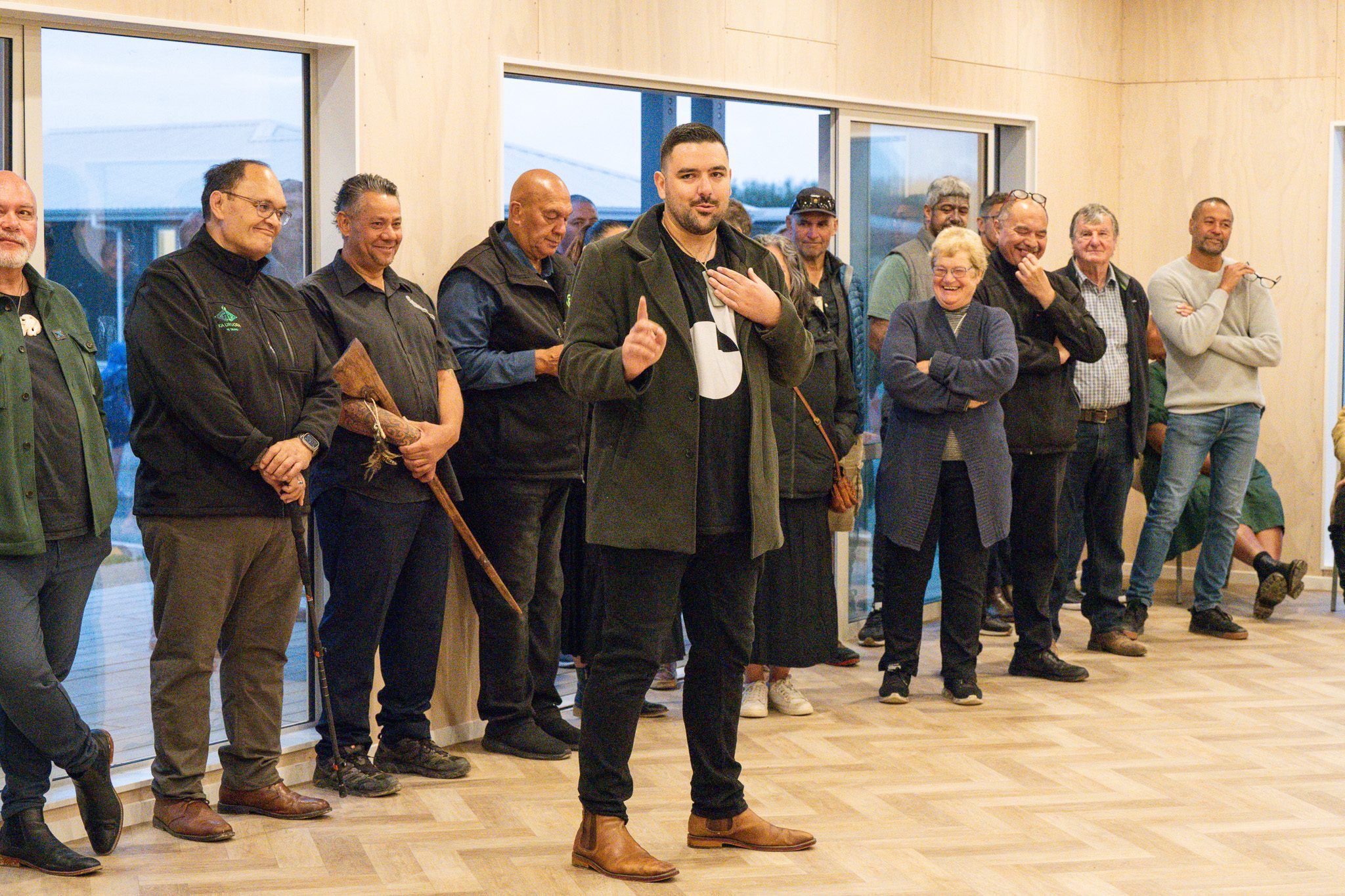 A speaker addresses whānau gathered inside the new building