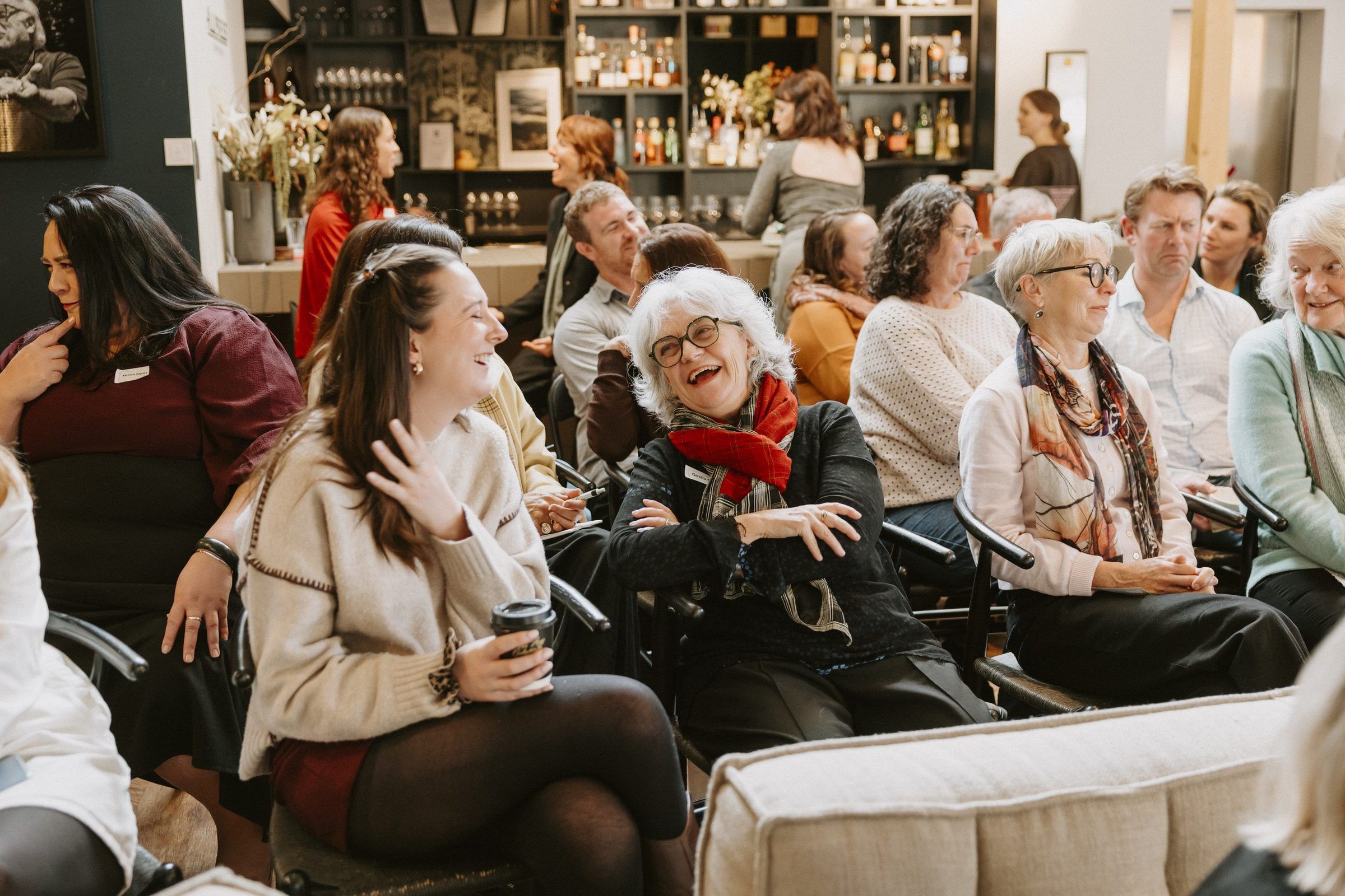An audience laughing together at the creativity and culture hui