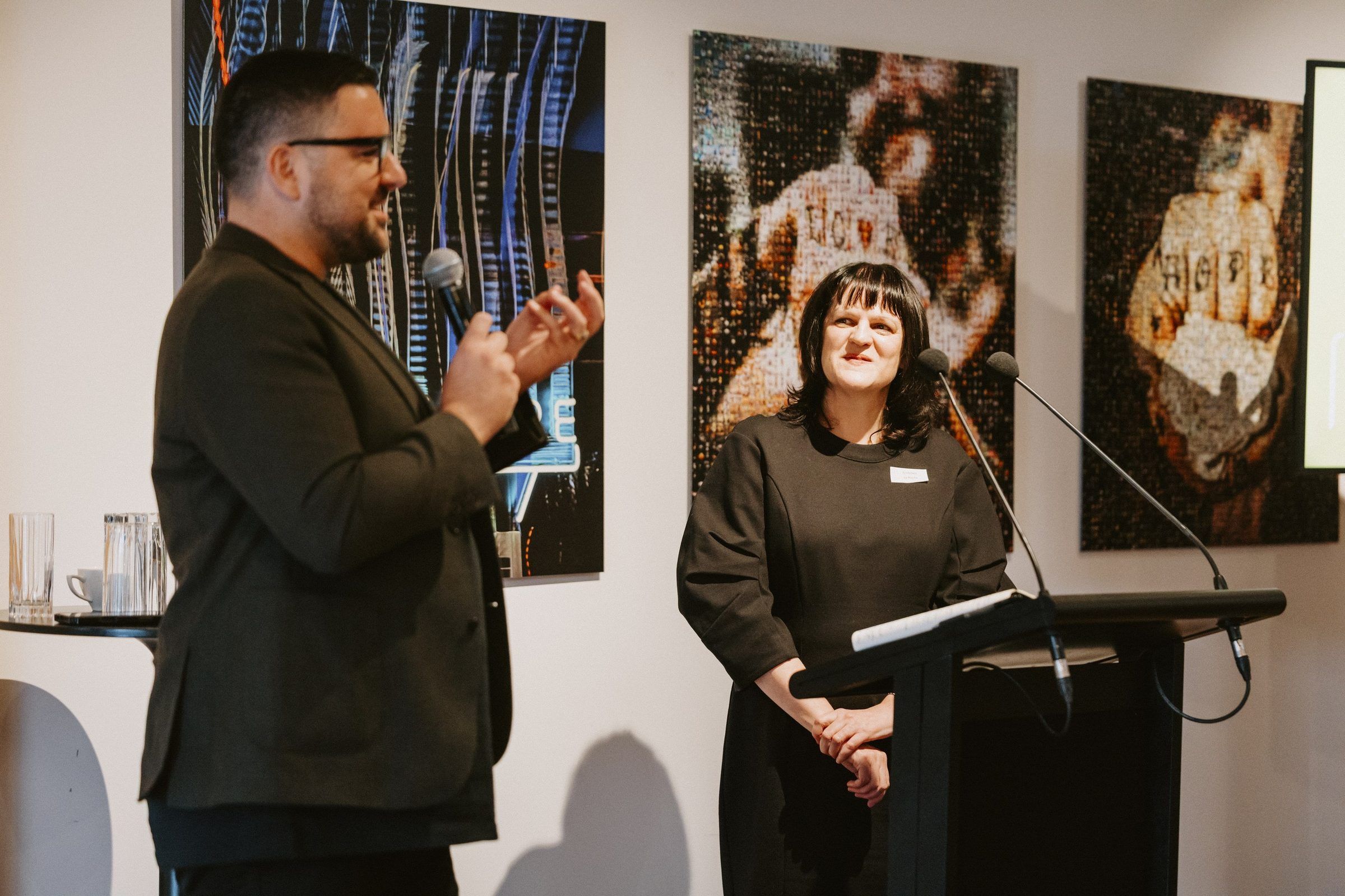 Johny O’Donnell and a speaker at the lectern address the hui
