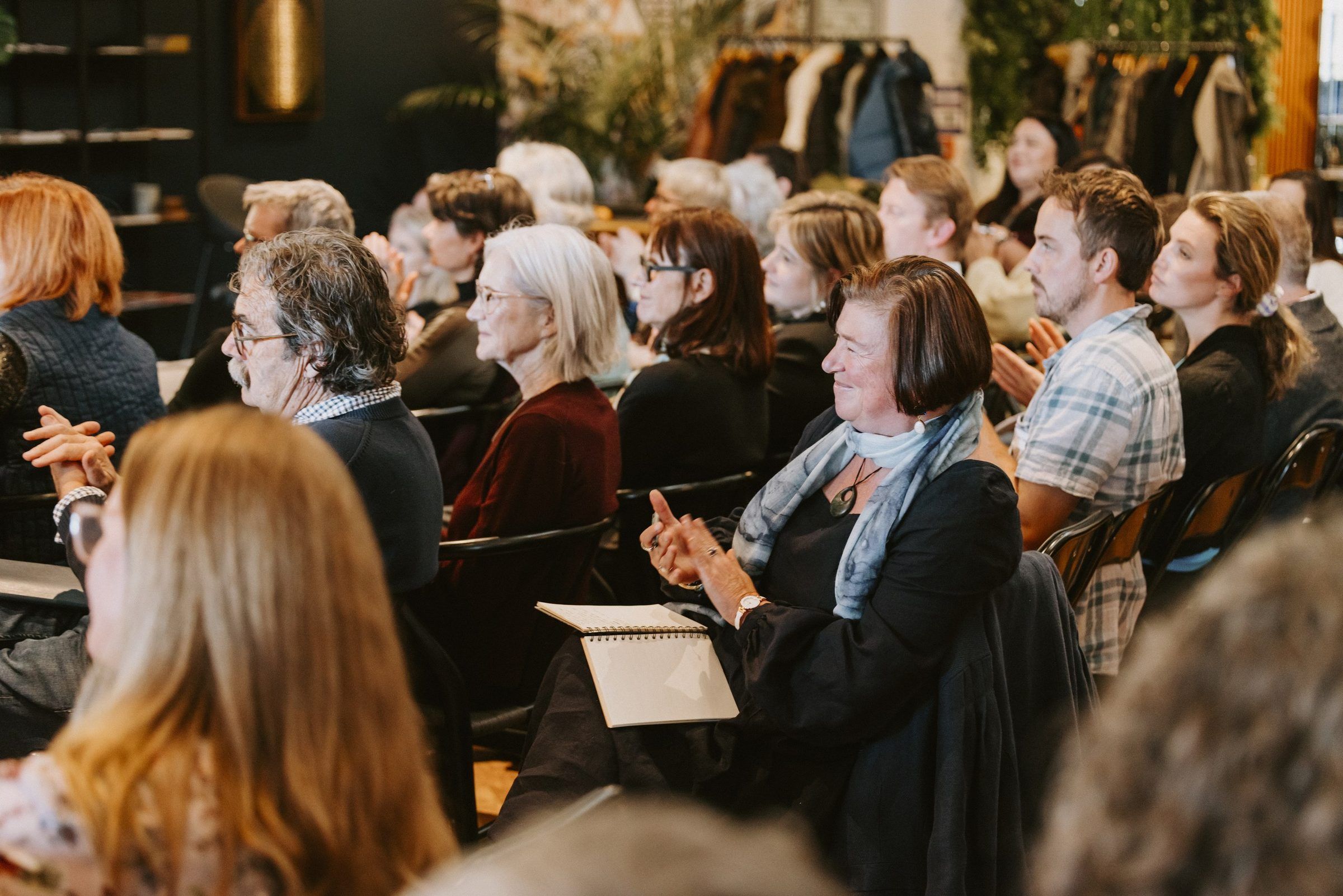 Participants listen and applaud during the hui