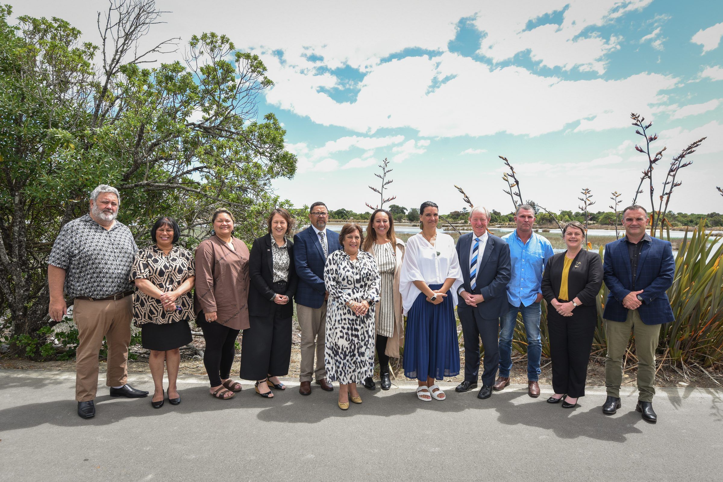 Iwi and council leaders stand together outdoors on the day of the signing