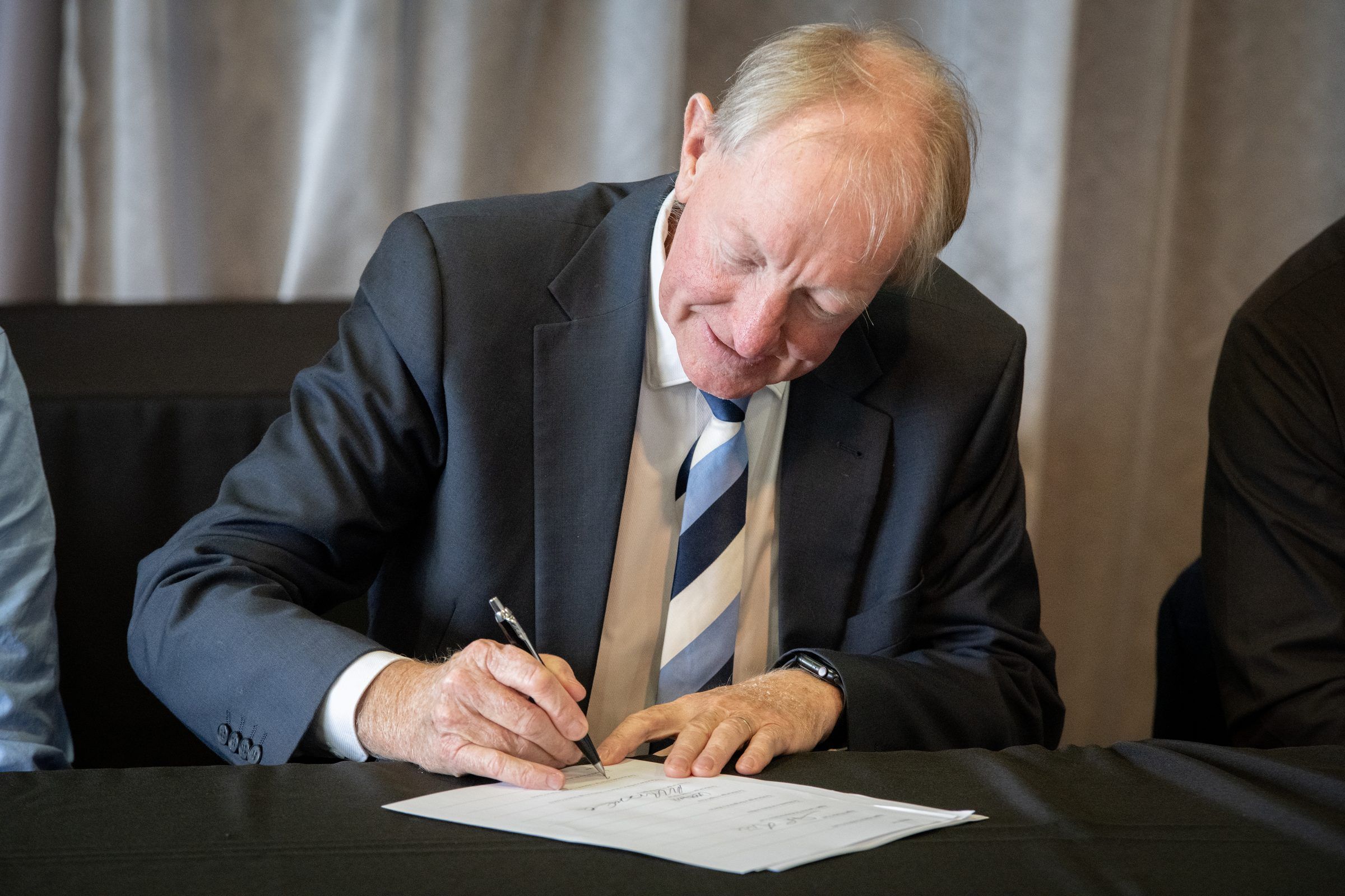 A leader signs the agreement
